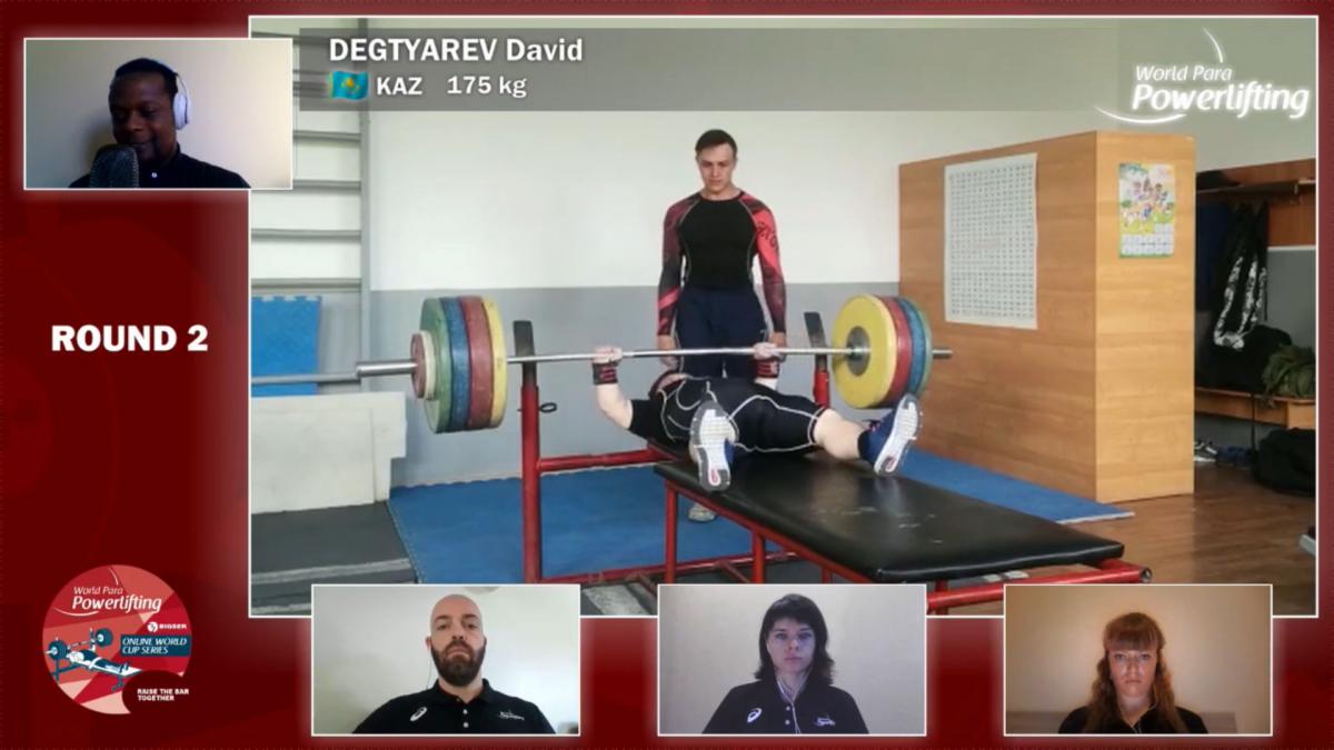 A screen showing a man lifting weight in a Para powerlifting competition and four windows showing four different persons watching it