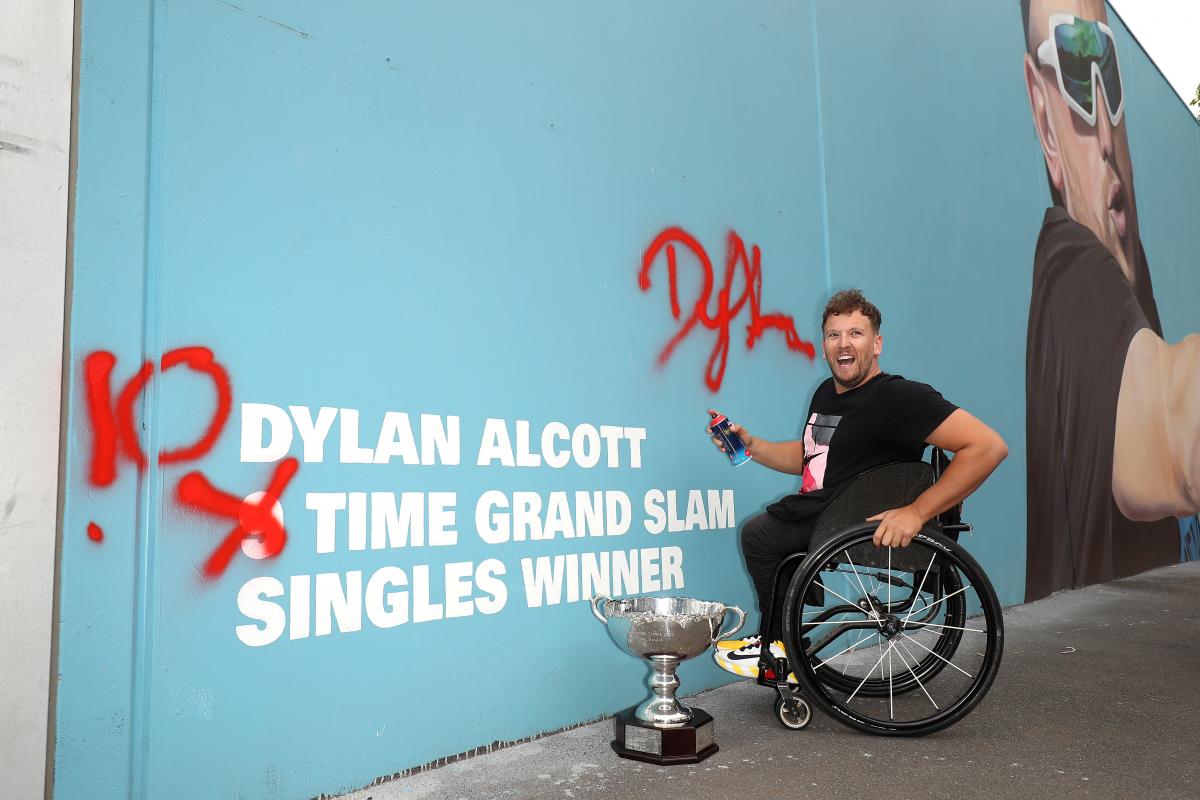 Male wheelchair tennis player next to wall art