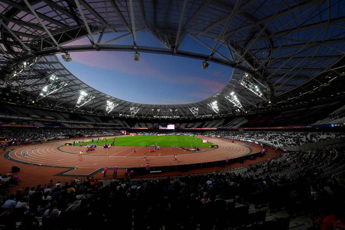 A general view of the London Stadium showing the stands, the athletics track with athletes competing