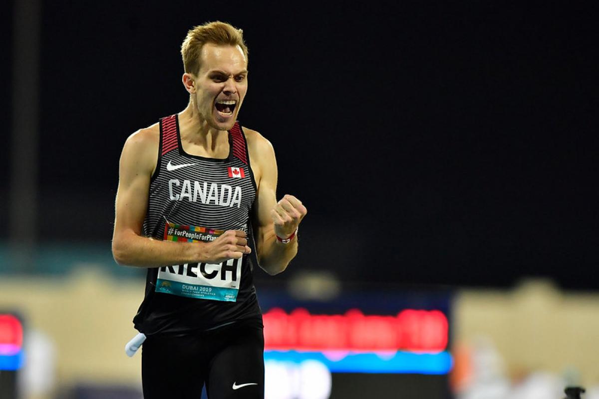 Canadian male distance runner celebrates