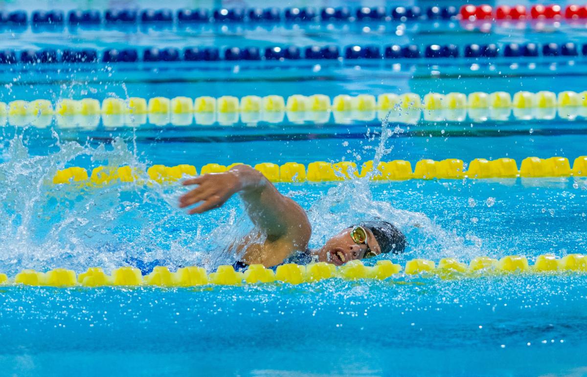 A woman swimming in a Para swimming competition