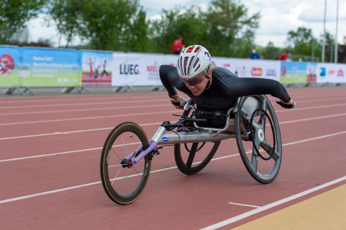 A woman in a racing wheelchair during a Para athletics race