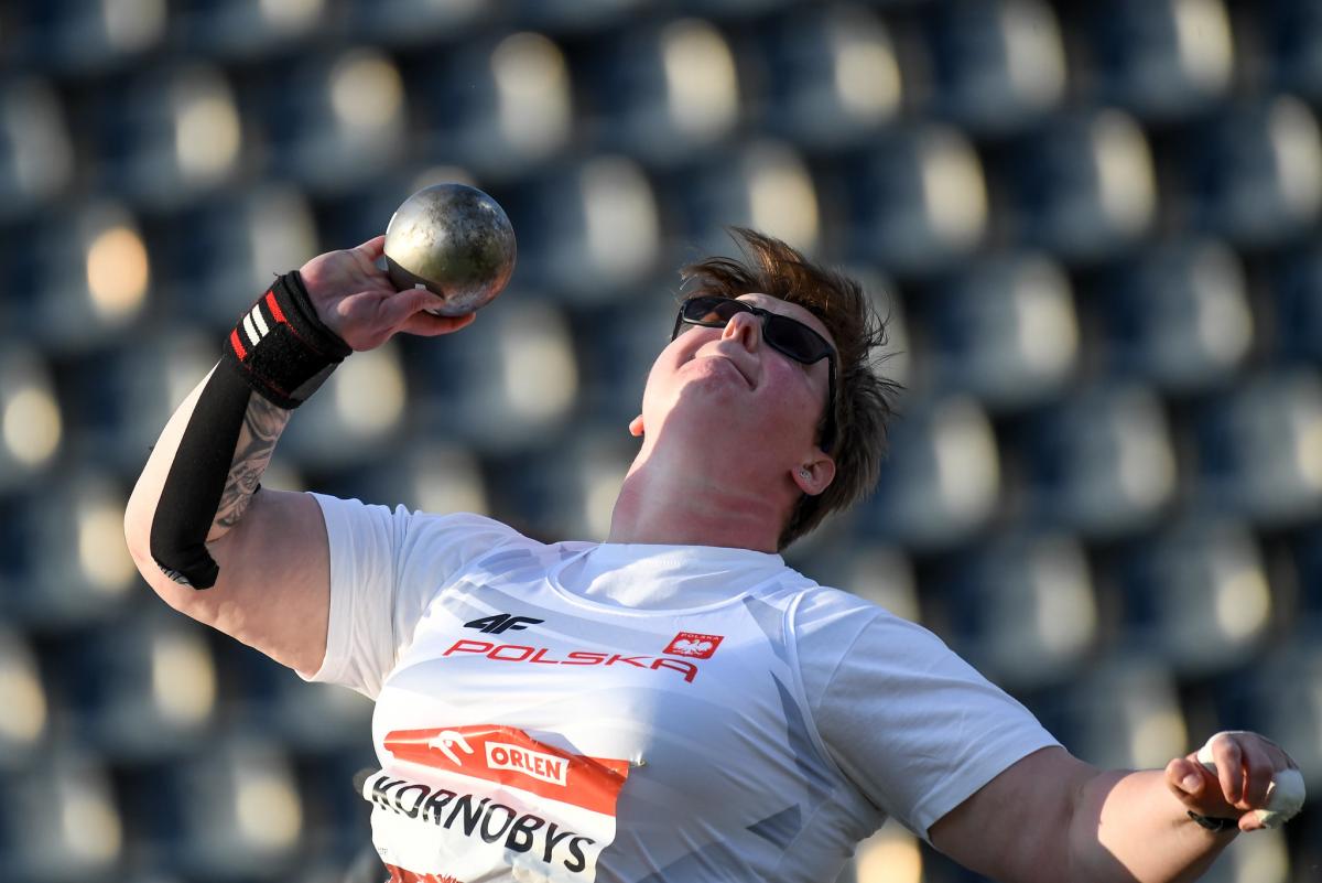 A woman competing in shot put 