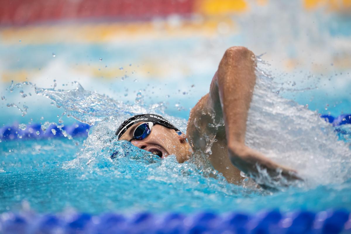 A man swimming freestyle in a pool