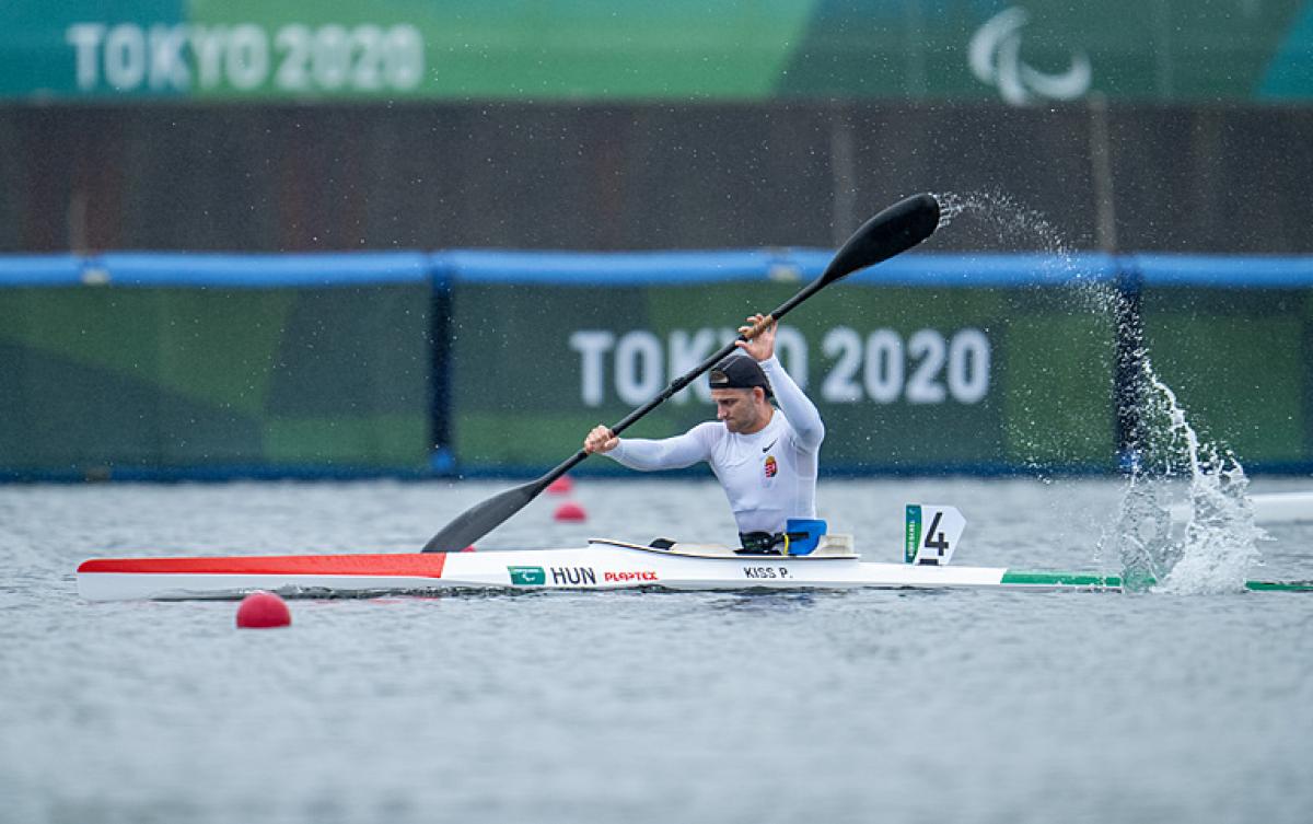 Peter Pal Kiss splashes water up in a strong stroke in his kayak