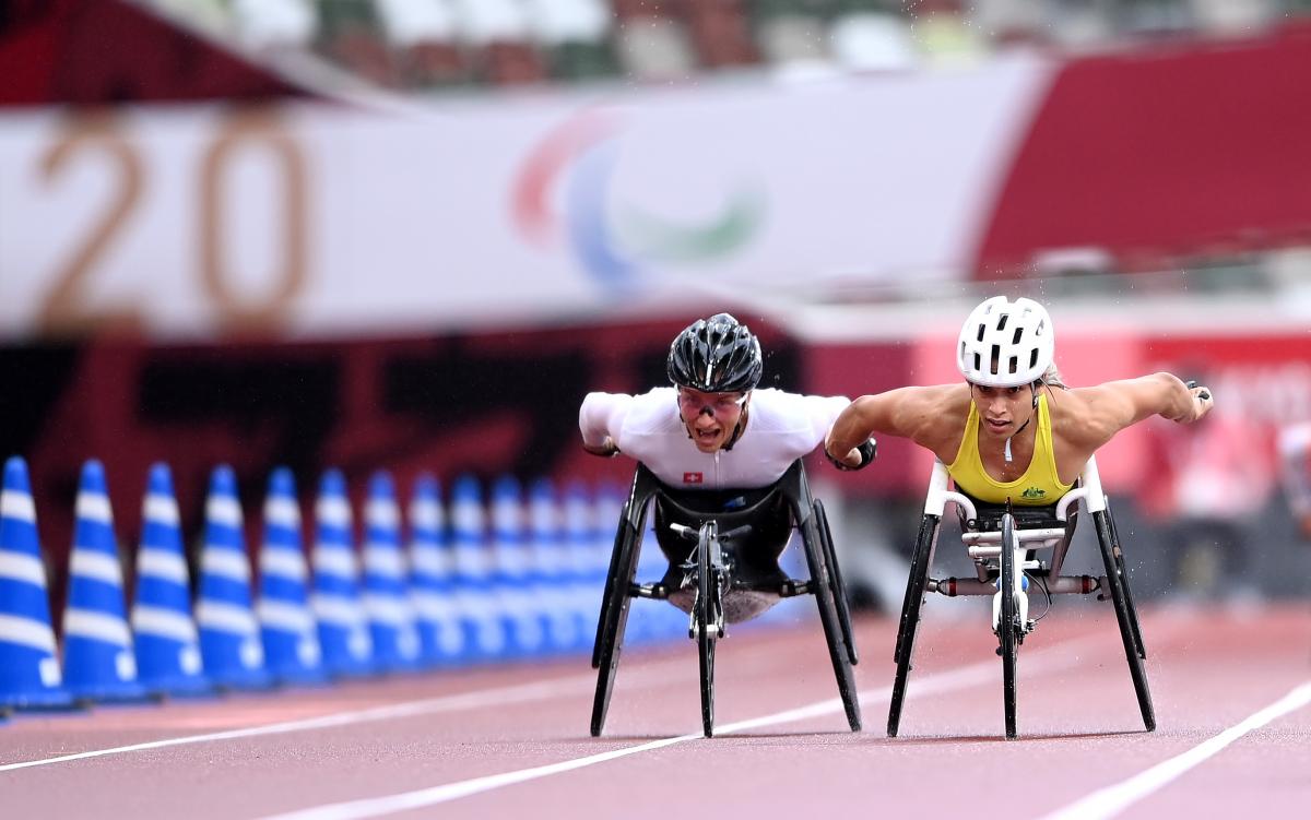 Two wheelchair racers getting close to the finish line