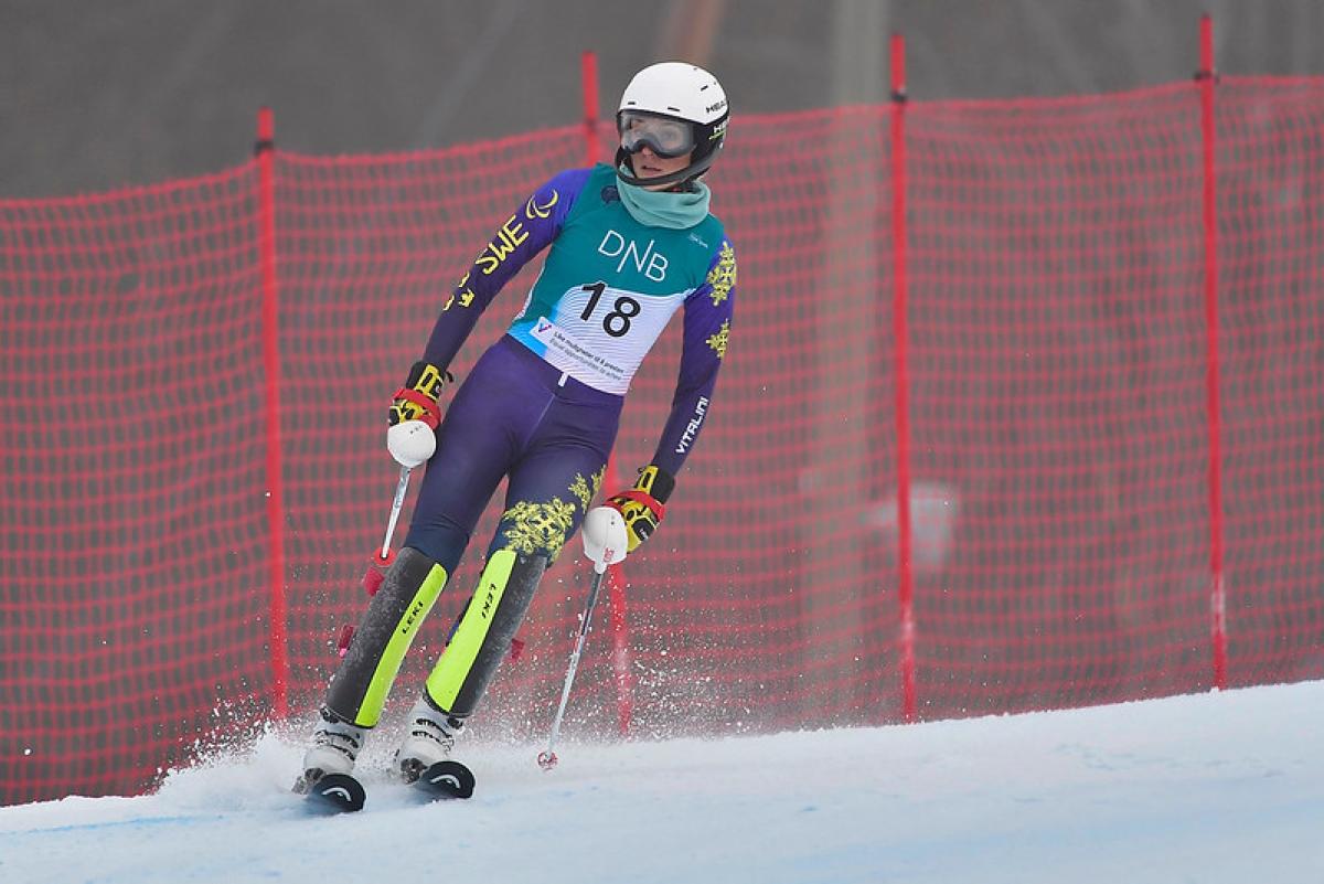 A female alpine skier on a course