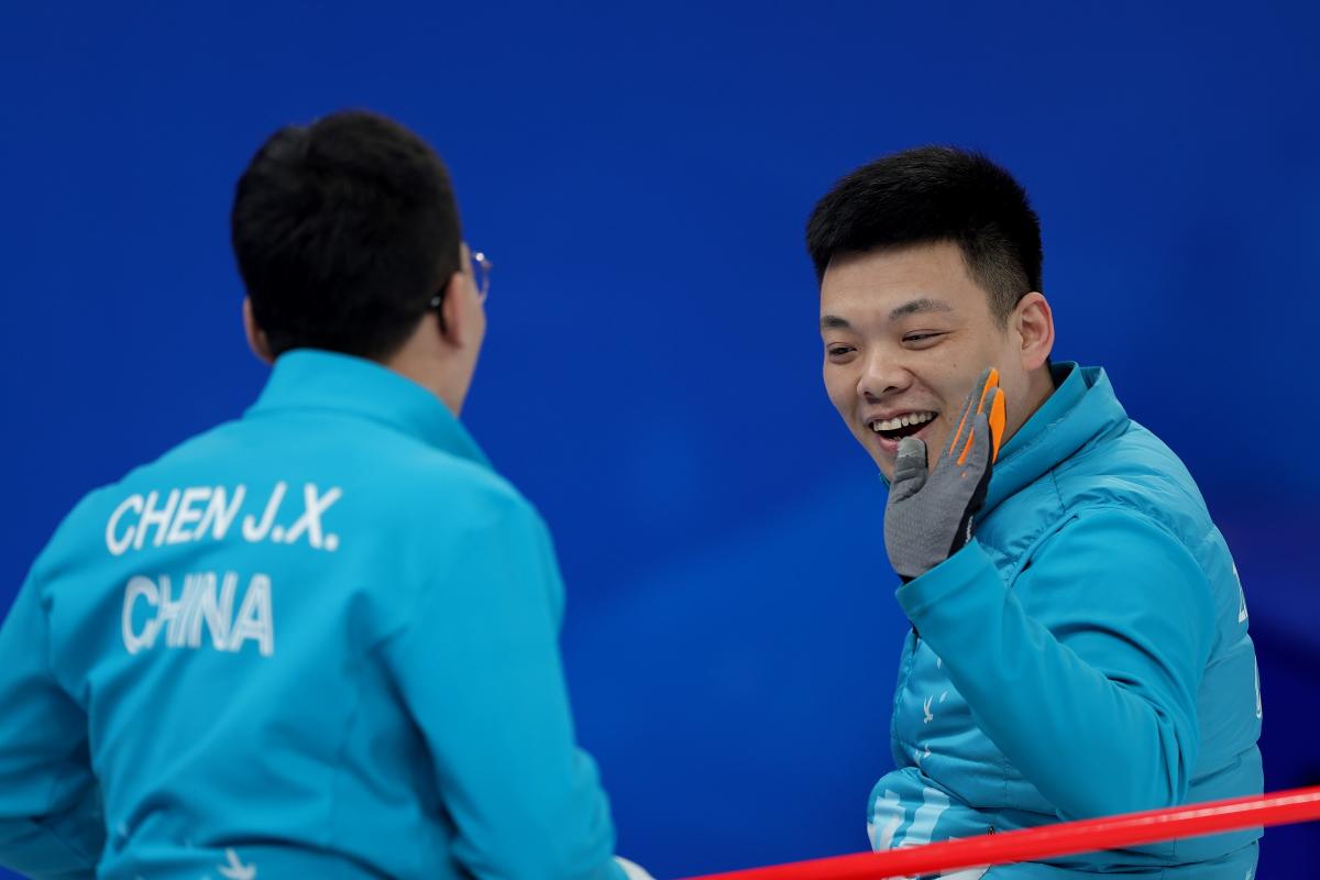 Chinese Wheelchair Curling team members celebrate during one of their Beijing 2022 matches