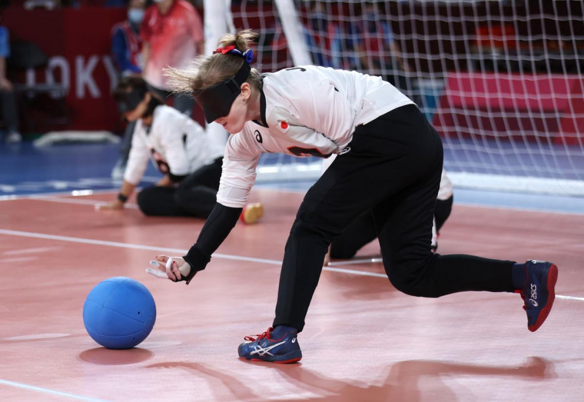 Japan's Eiko Kakehata releases the ball to the ground, fingers outstretched, as she shoots during her team's semifinal match against Team Brazil at the Tokyo 2020 Paralympic Games.