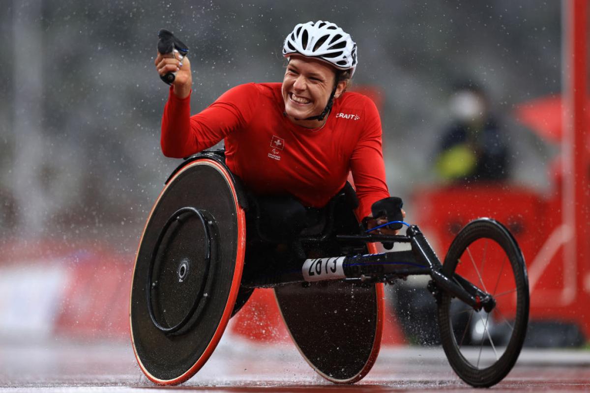 Image of a female Para Athletics athletes happy after she crosses the finish