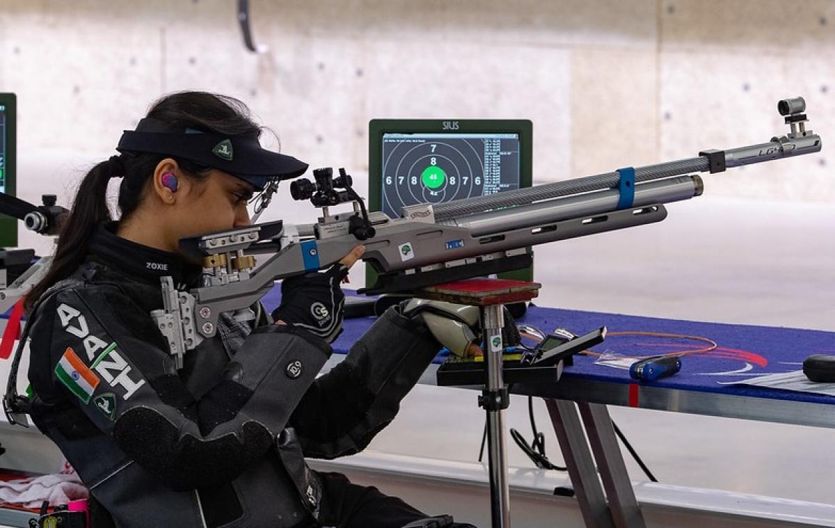 A female shooter with a rifle in a shooting Para sport competition