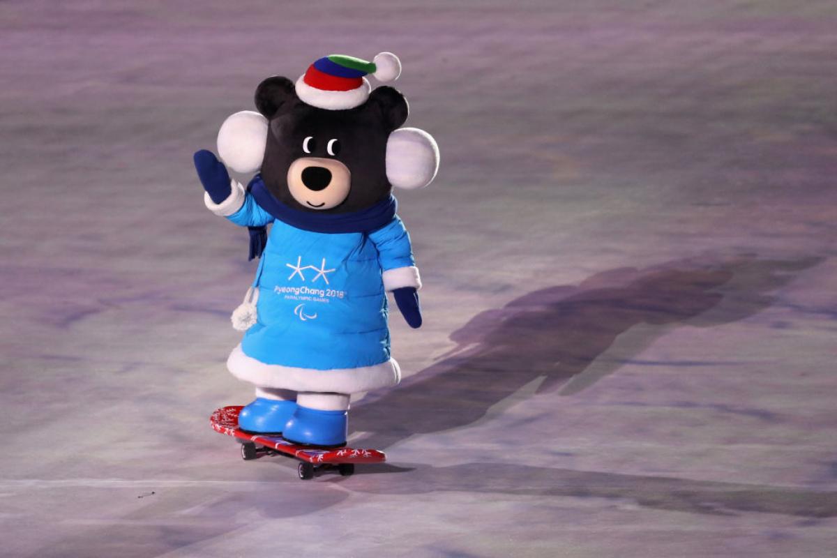 A PyeongChang 2018 mascot rides a skateboard and waves during the Games Opening Ceremony.