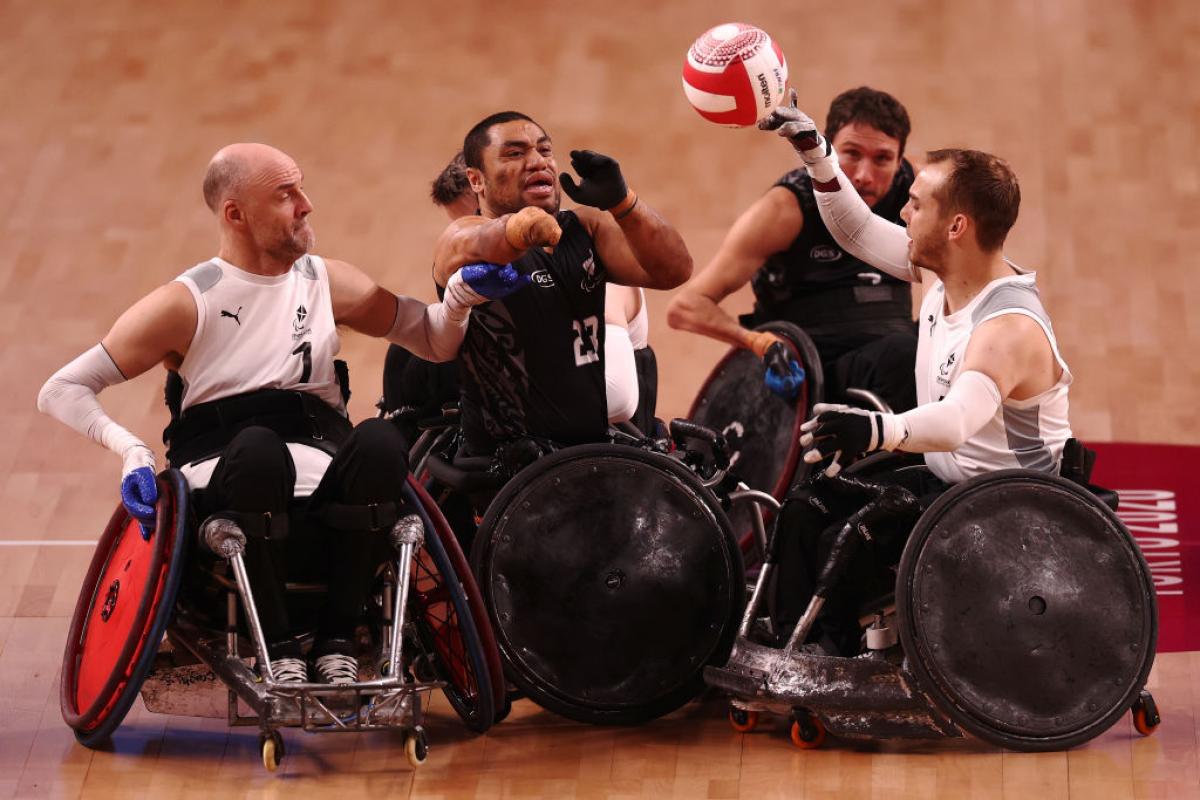 Five players from the Denmark and New Zealand teams battle for the ball.