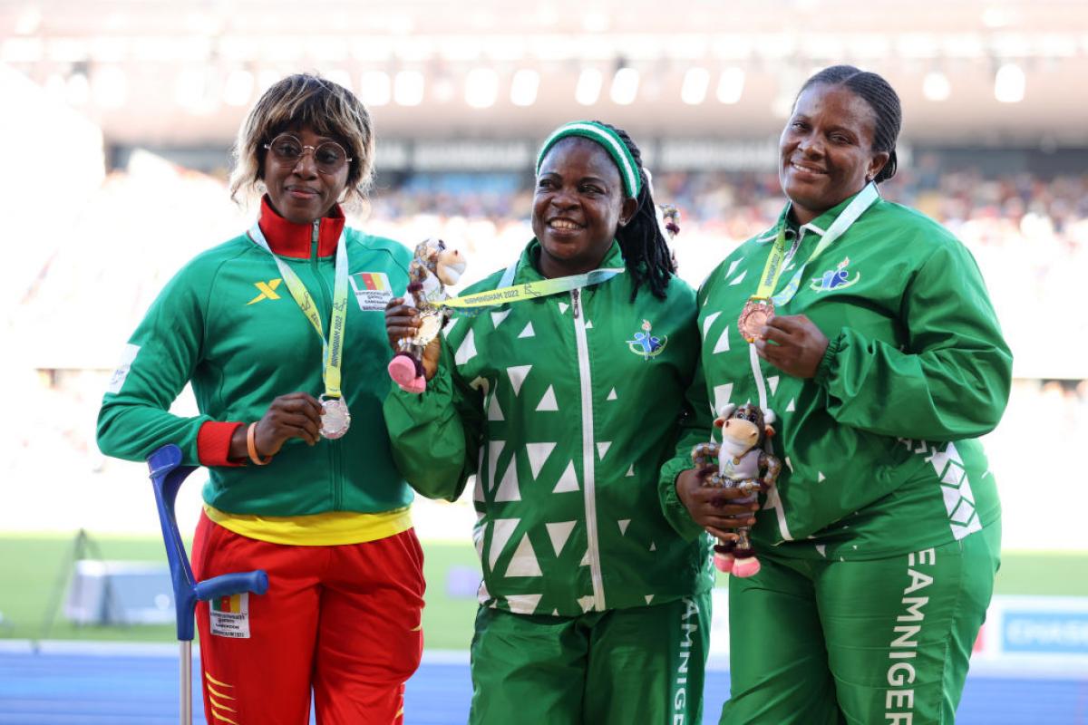  Eucharia Iyazi (centre) of Nigeria with her team mate and bronze medallist Ugochi Alam and silver medallist Arlette Mawe Fokoa of Cameroon pose for a photo during the medal ceremony for the women's shot put F55-57 at the Birmingham 2022 Commonwealth Games.