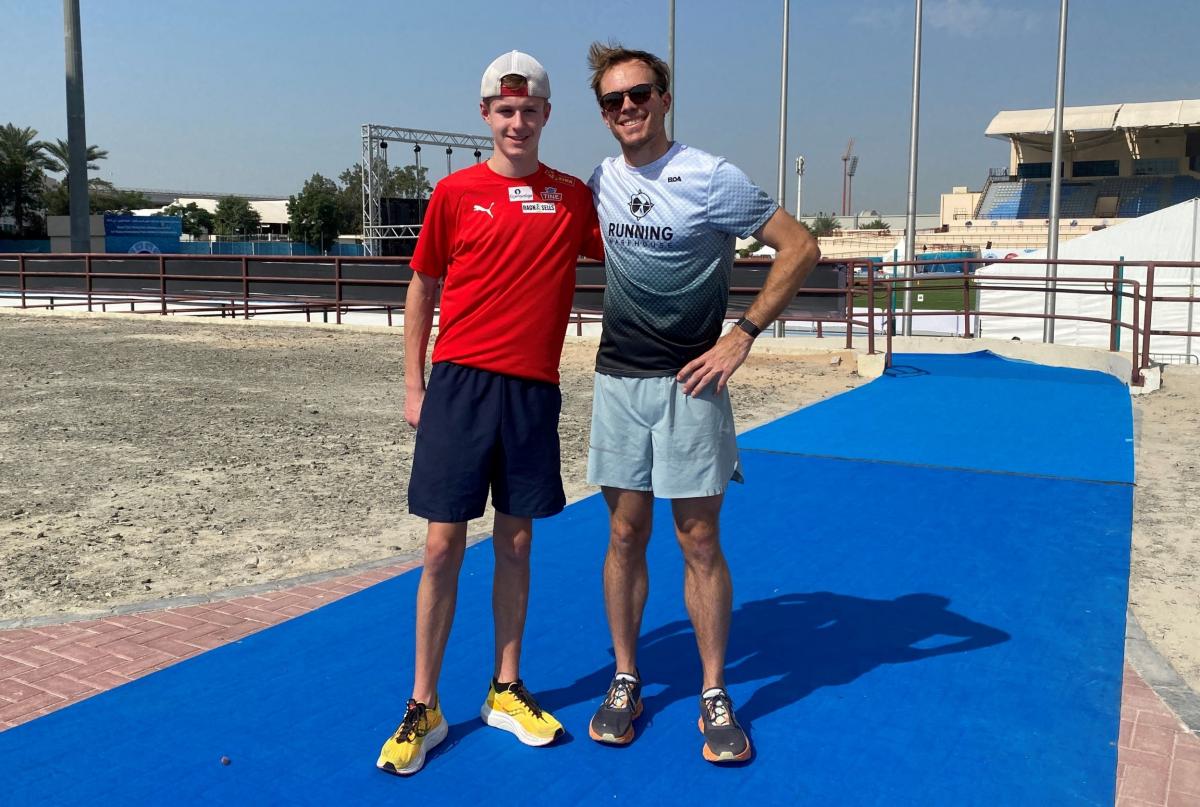 Two male athletes posing for a photograph.