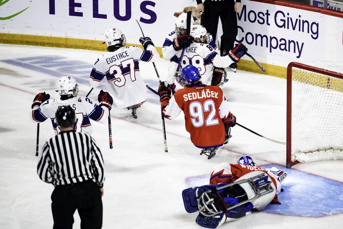 Four US Para ice hockey players celebrating against Czechia 