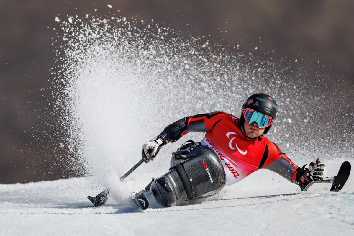 A male athlete competes on a sit-ski.