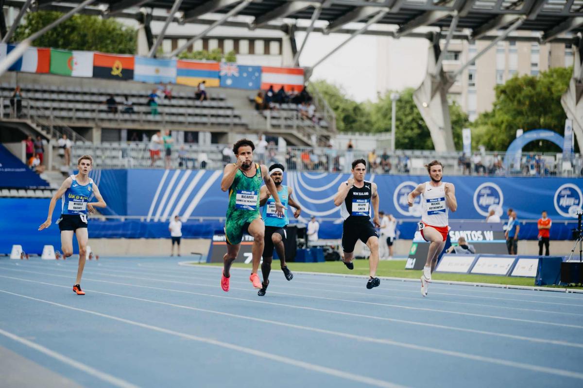 Five male sprinters in a Para athletics race