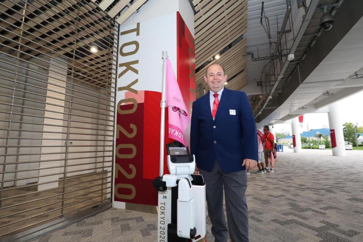 A man wearing a suit standing in the external area of a stadium