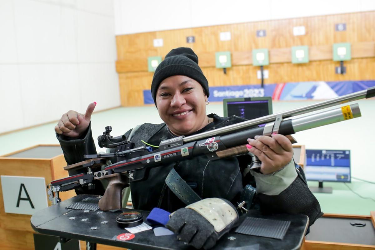 A female Para athlete with a rifle in a shooting range