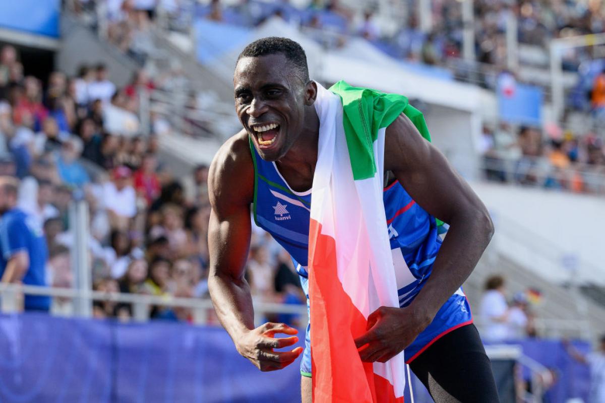 A male athlete celebrates after a win.