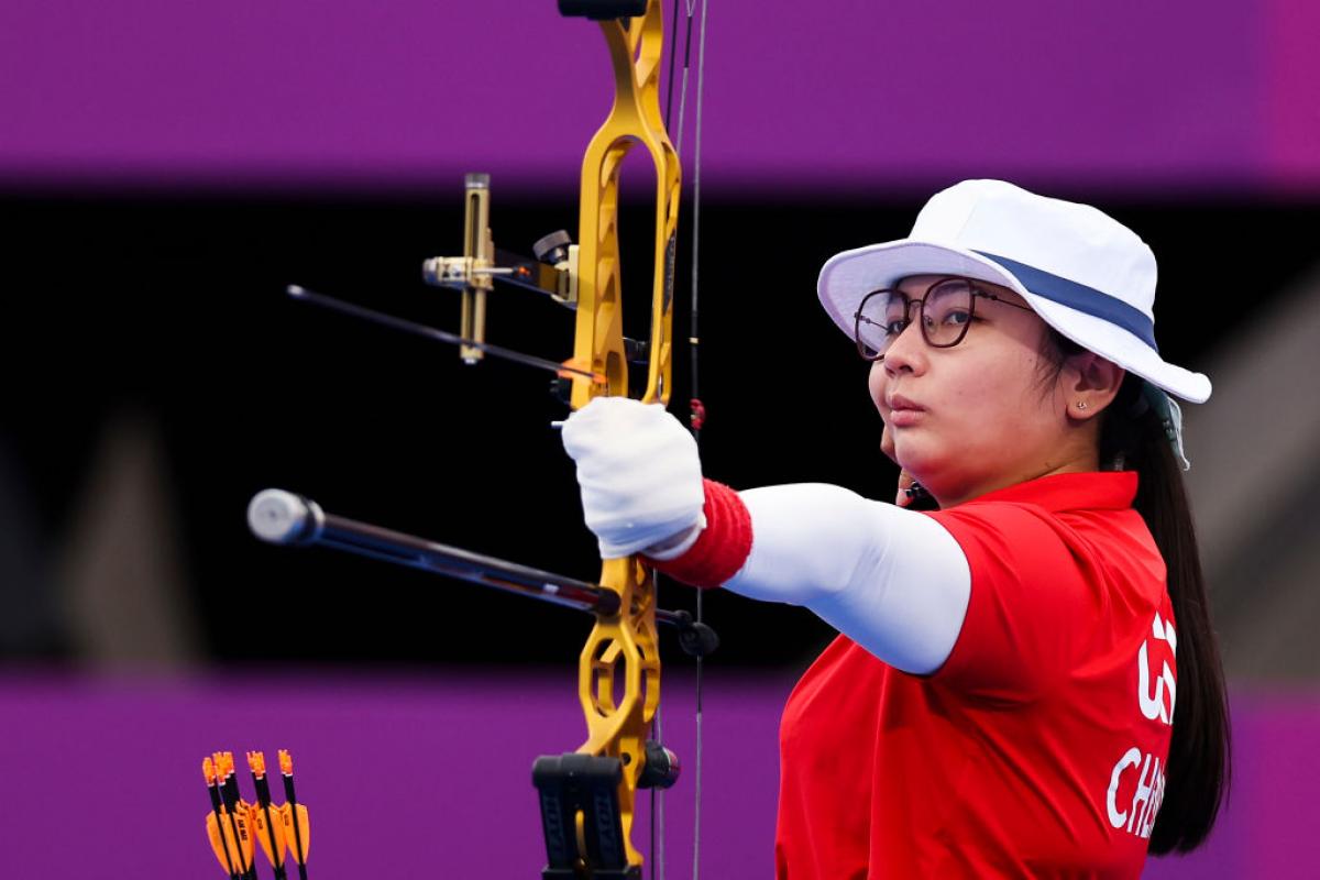 Para archer Chen Minyi aims her bow and arrow ready to shoot 