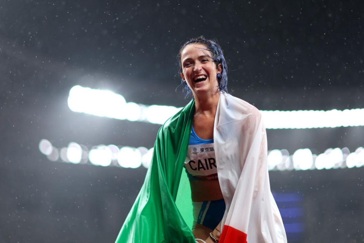 Para sprinter Martina Caironi laughing with the Italian flag wrapped round her