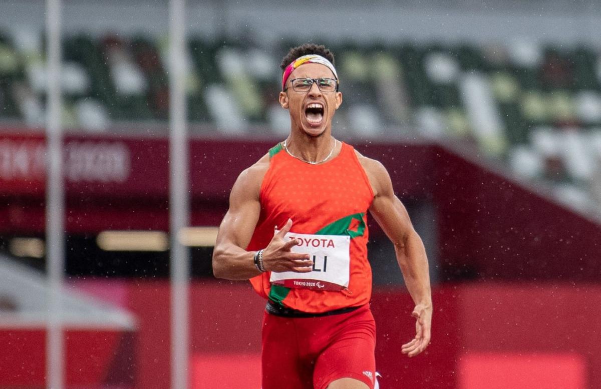 A male runner shouting in a stadium