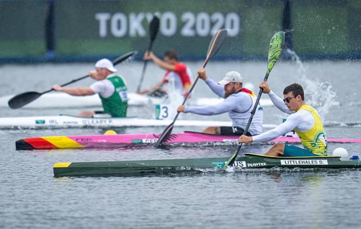 four male Para canoeists paddling in a race