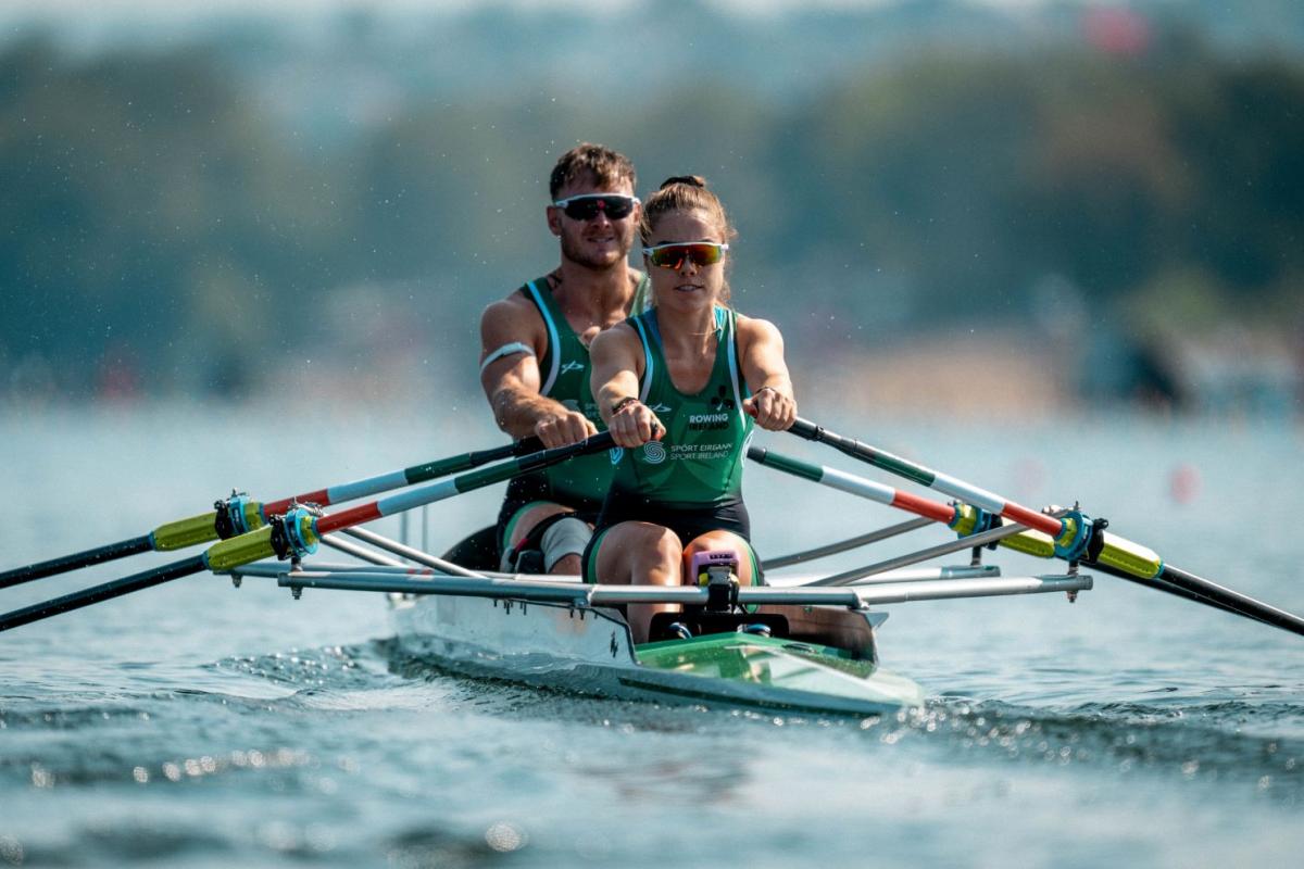 A female and male Para rowers competing.