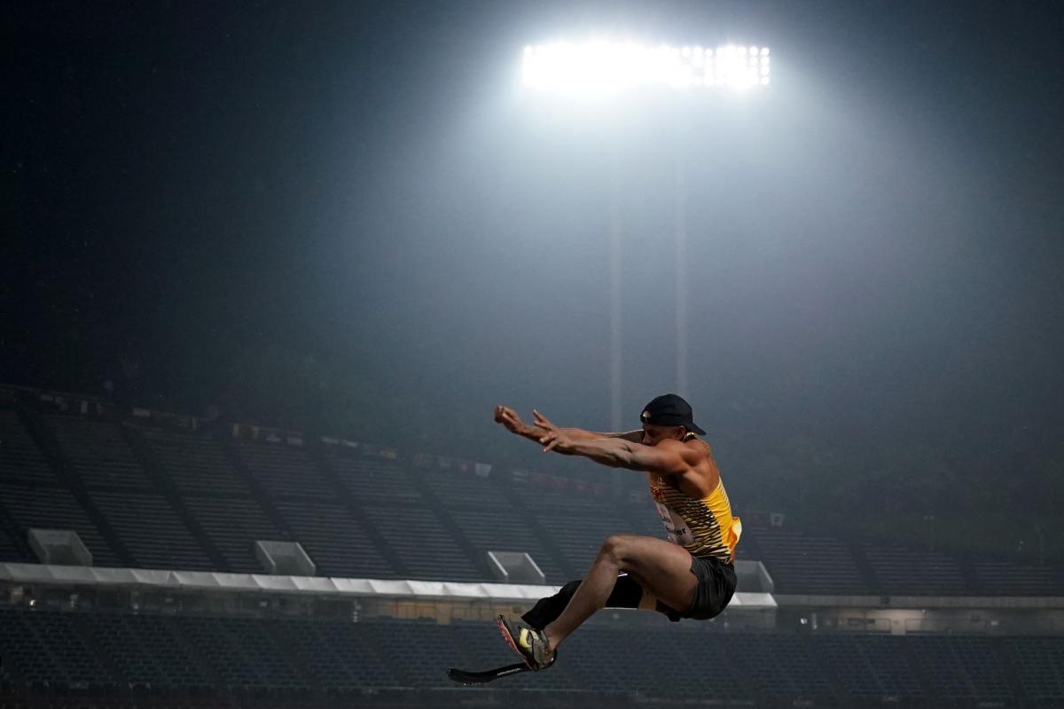 A man with a prosthetic leg in a long jump competition