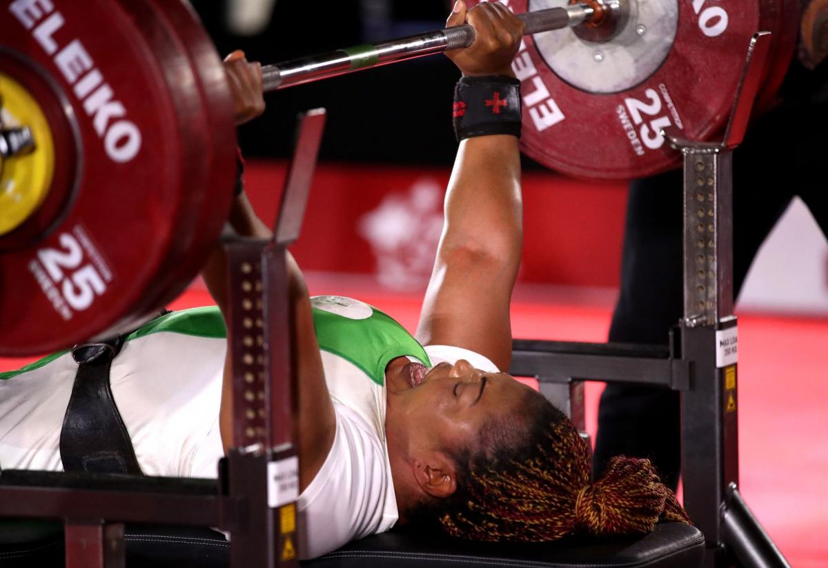 Lucy Ejike of Nigeria lifts weights during competition