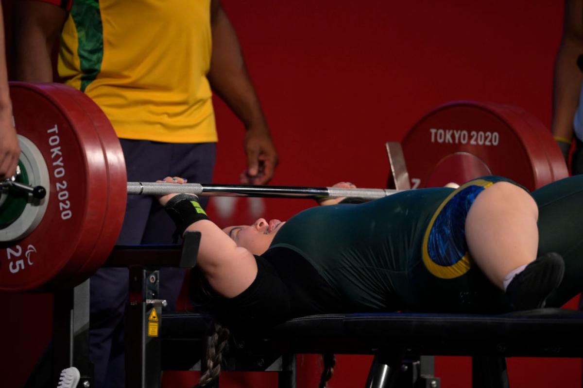 A female athlete lifts weights