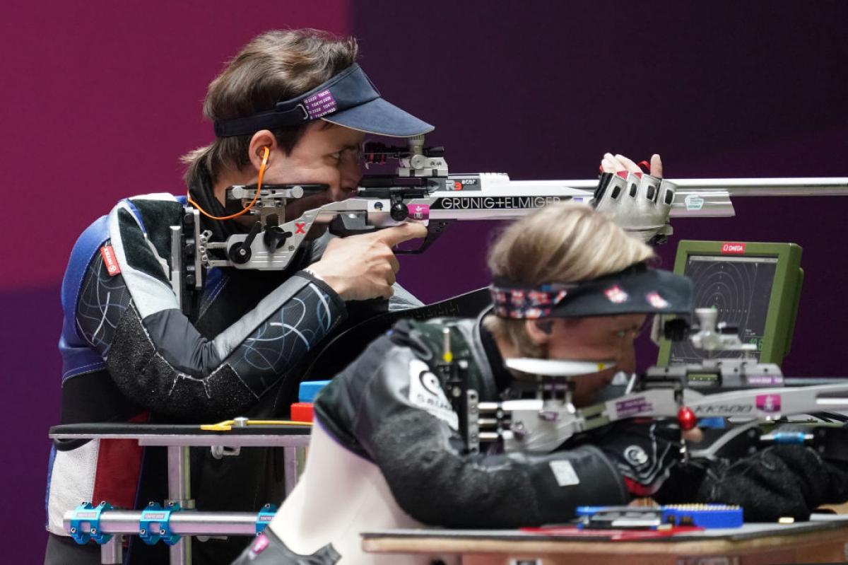 Two female shooters side by side aiming for the target at the Tokyo 2020 Paralympics.