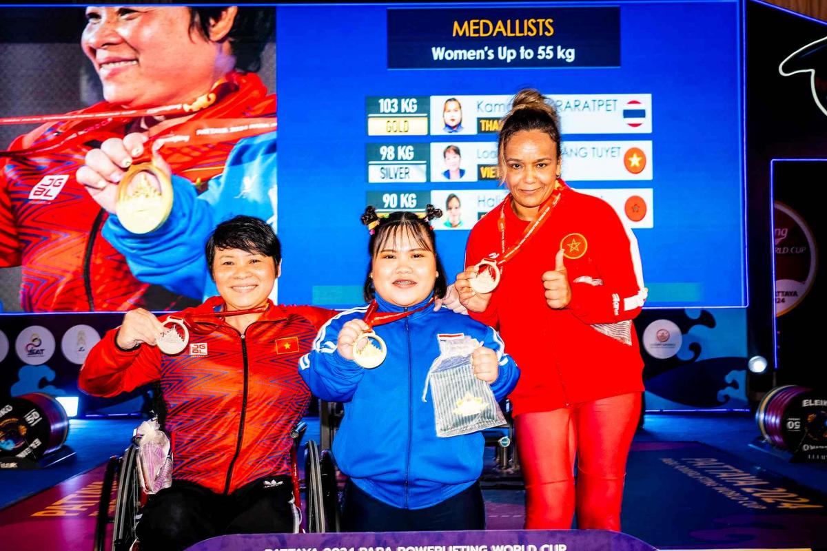 Medallists pose at podium