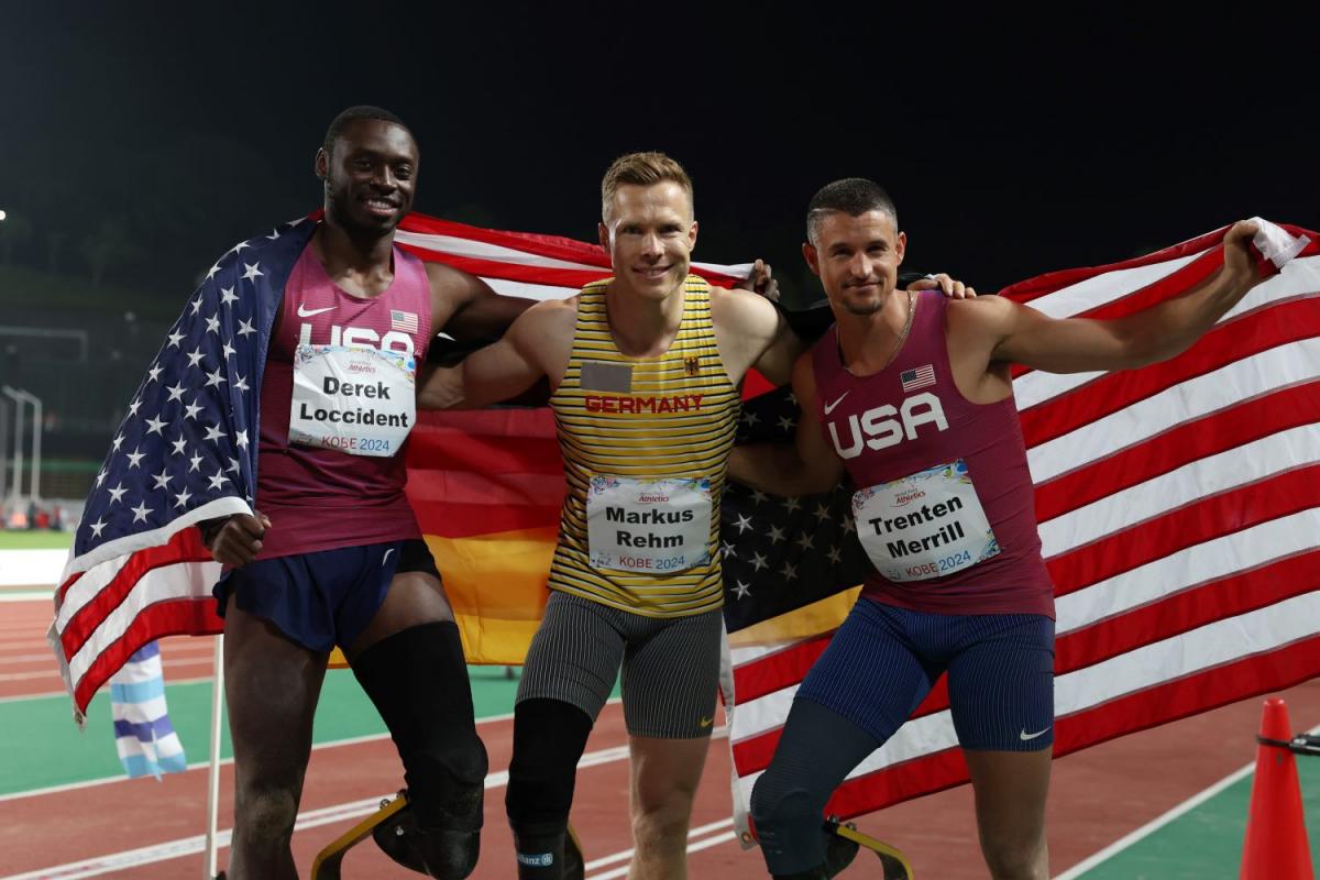 Three men with prosthetic legs posing for a picture in a competition