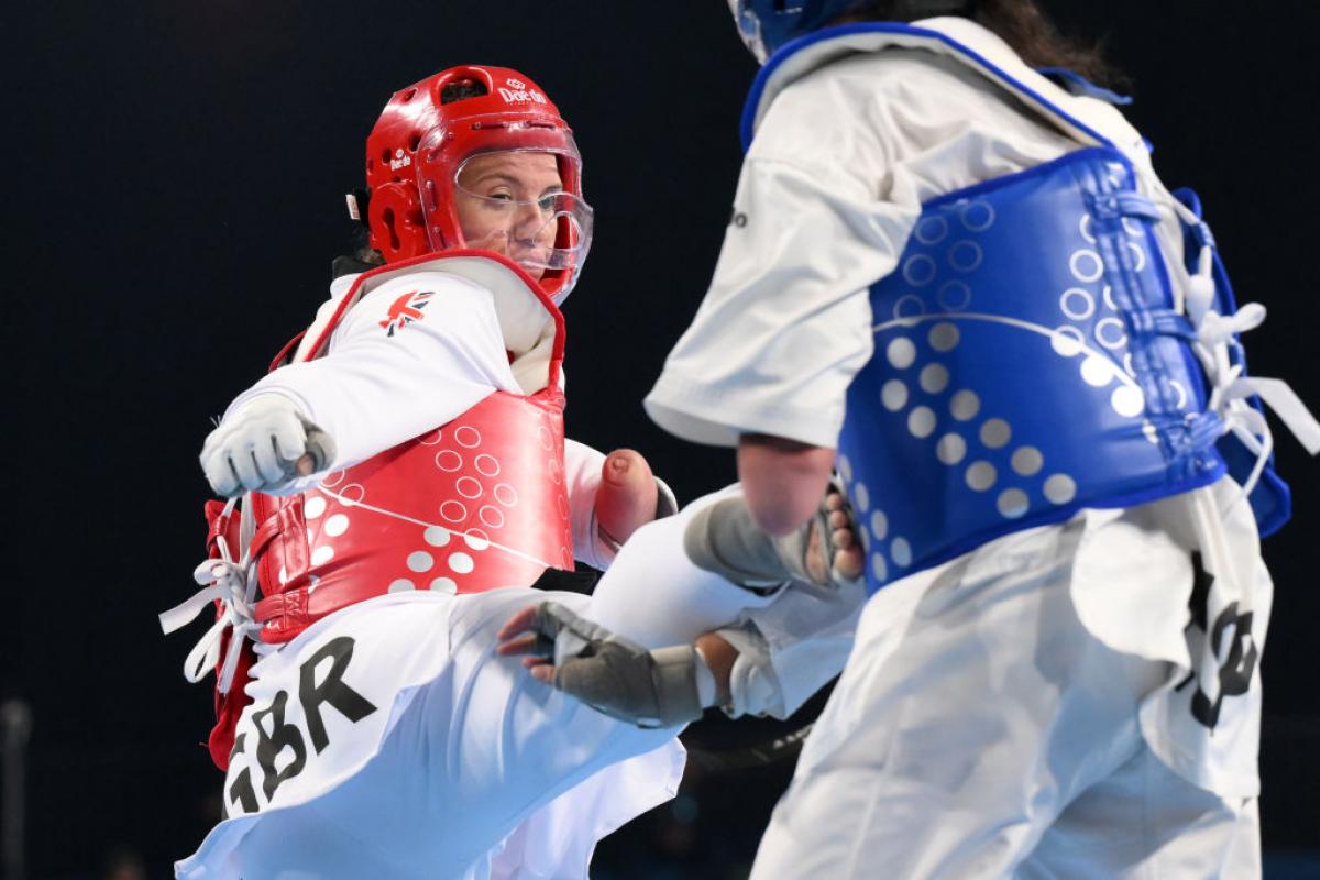 A female athlete kicks her opponent