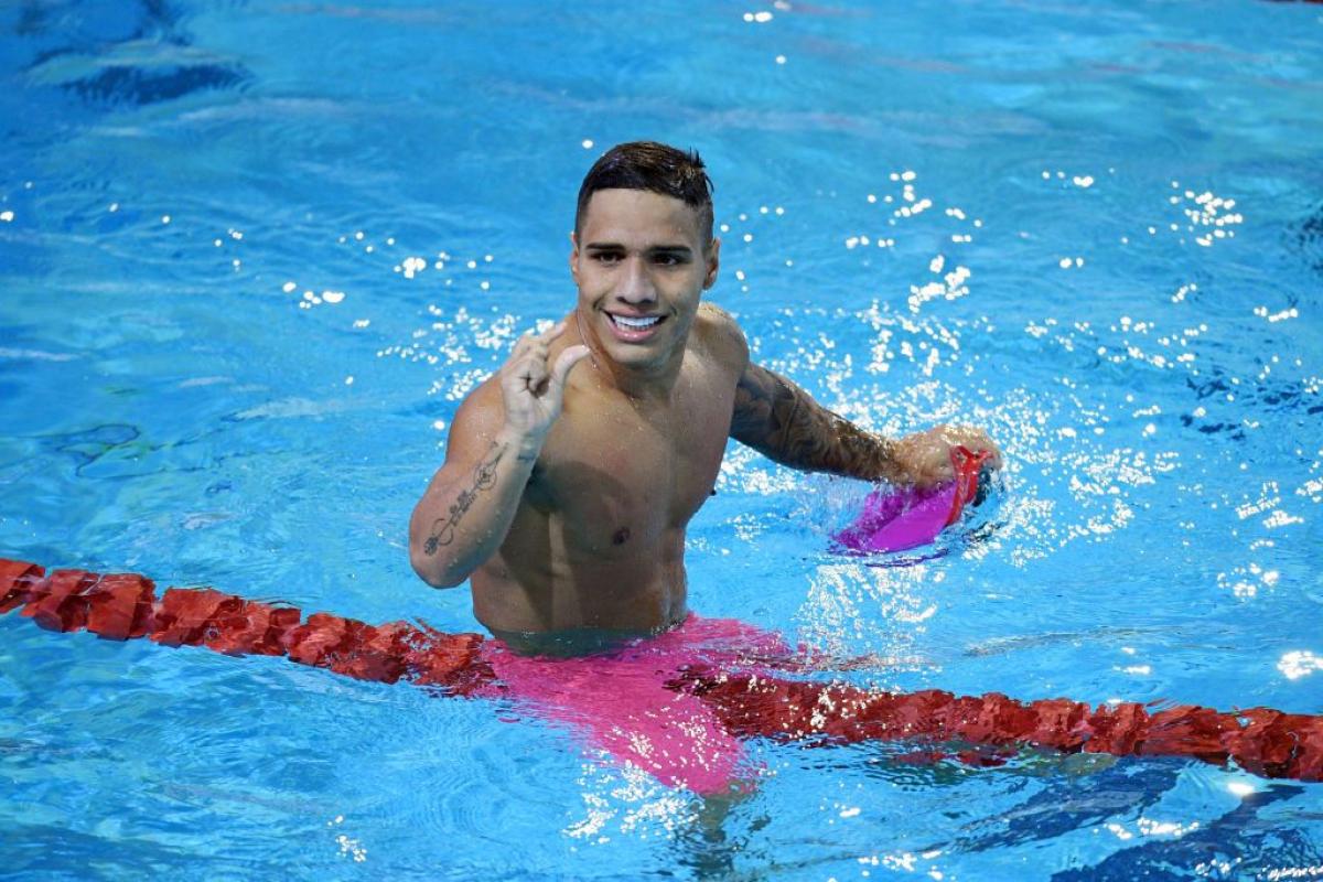 A male Para swimmer competes 