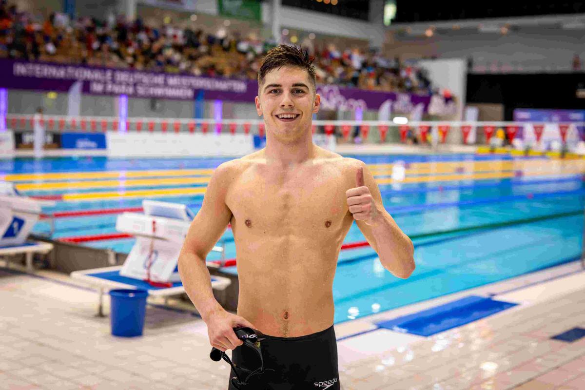 A swimmer gestures after his race