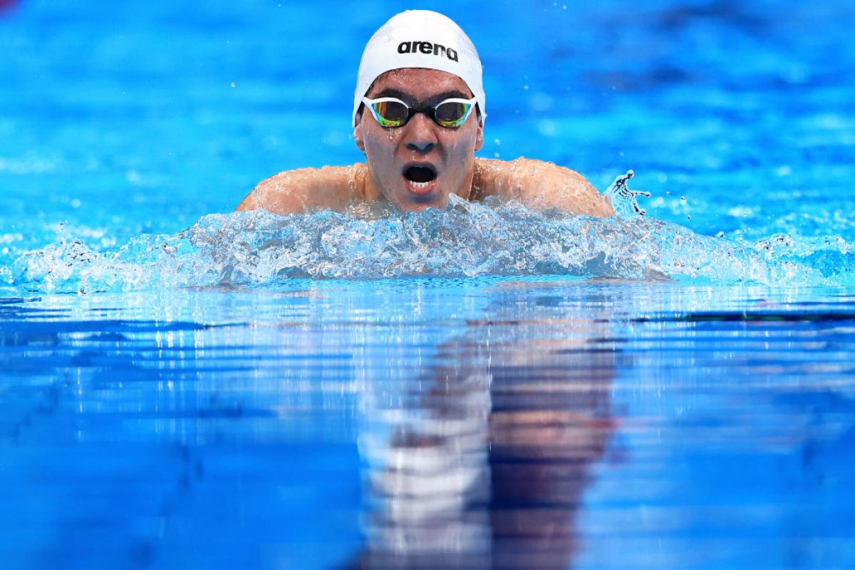 A male Para swimmer competes