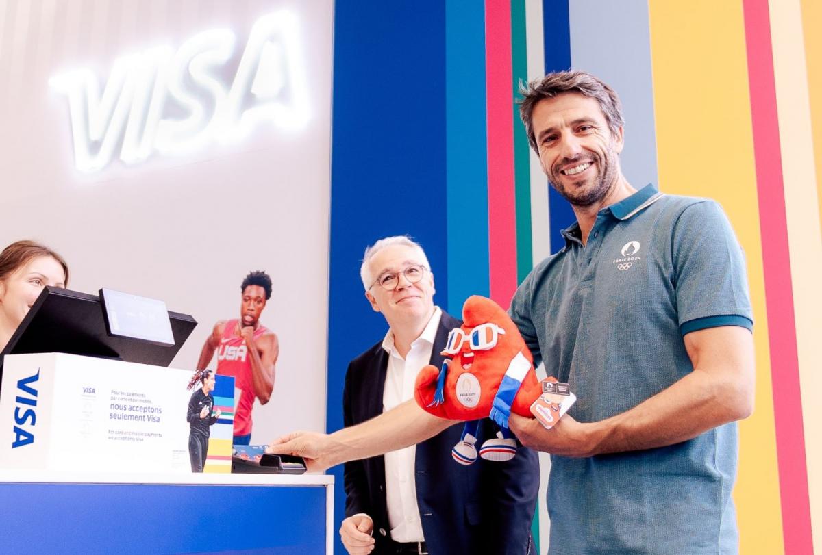 Paris 2024 President Tony Estanguet poses for a photograph while holding the Games mascot Phryge at the megastore
