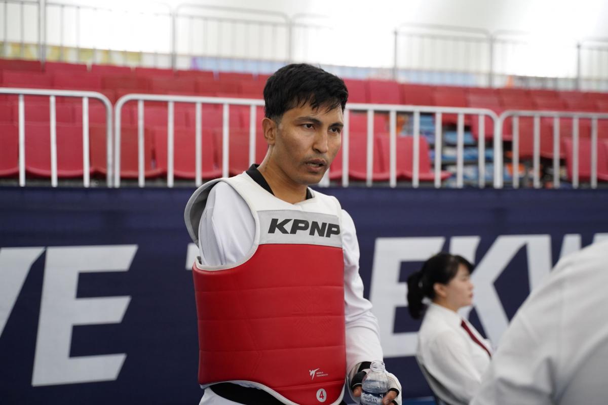 Hadi Hassanzada, a member of the Refugee Paralympic Team at Paris 2024, is photographed wearing the taekwondo gear.