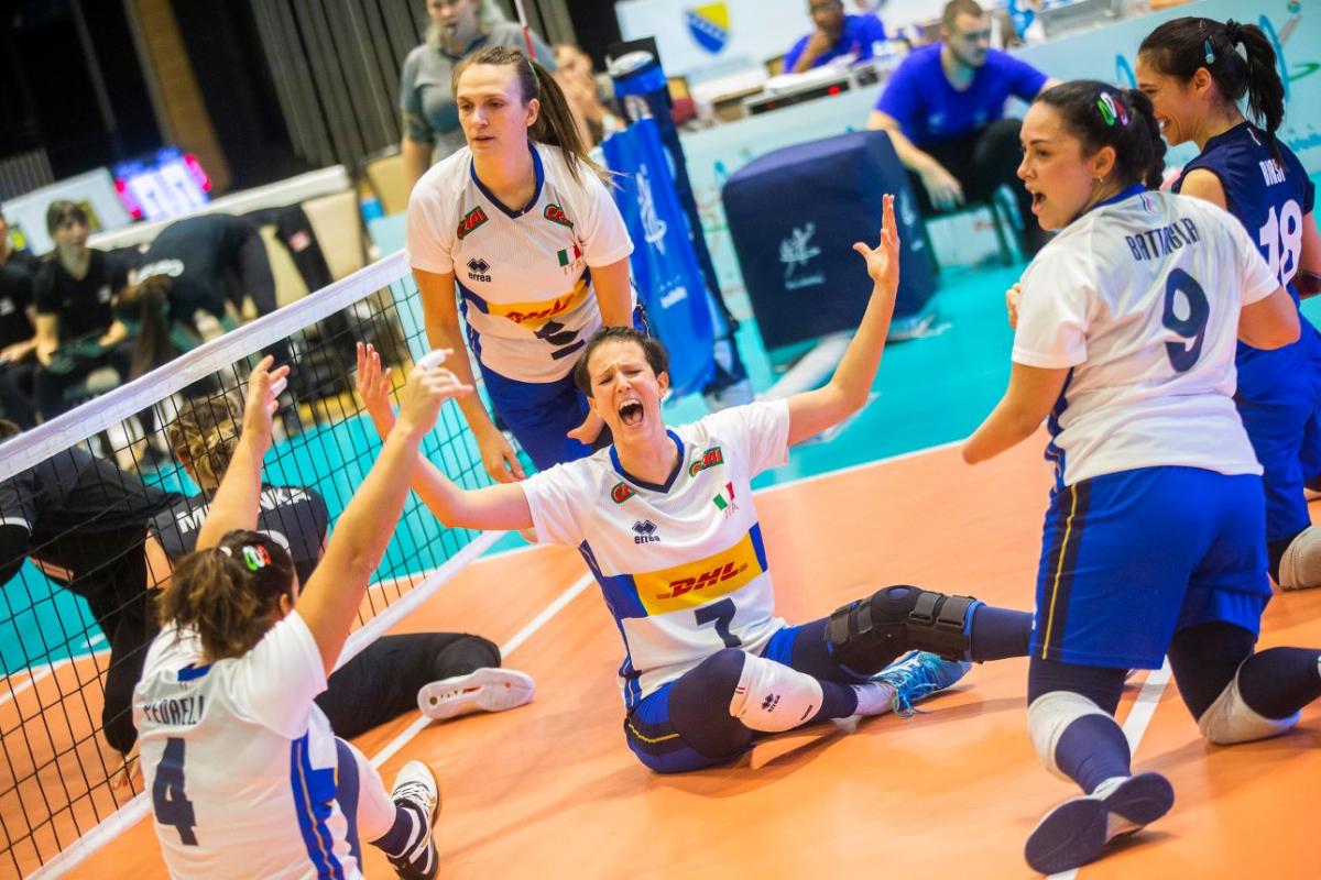 Sara Cirelli, a female sitting volleyball player, celebrates with her teammates.