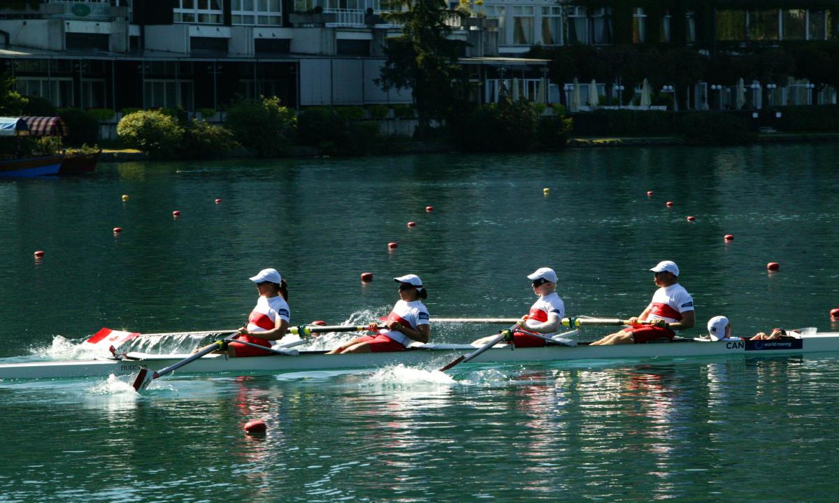 A picture of 4 people rowing