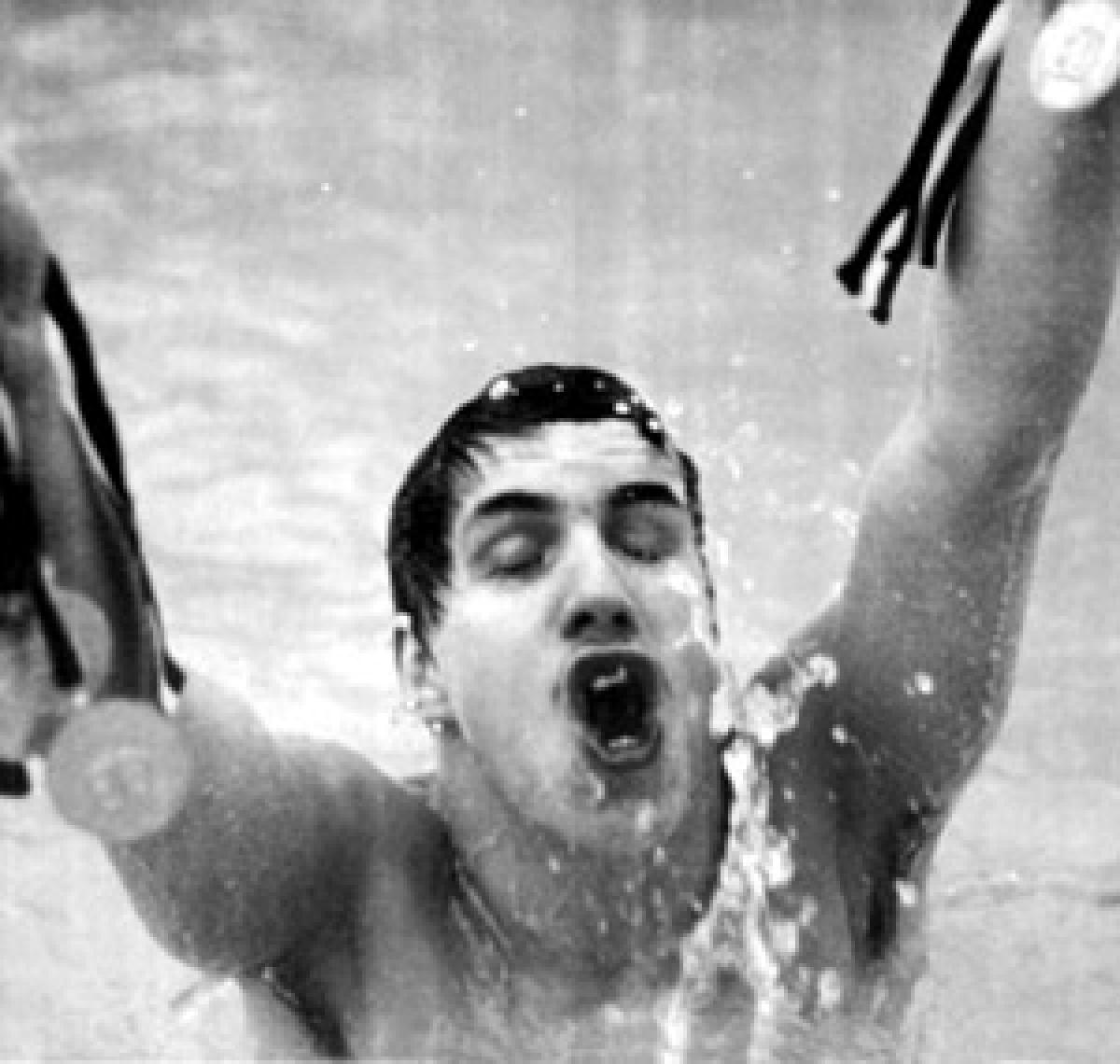 A picture of man in a pool celebrating his victory