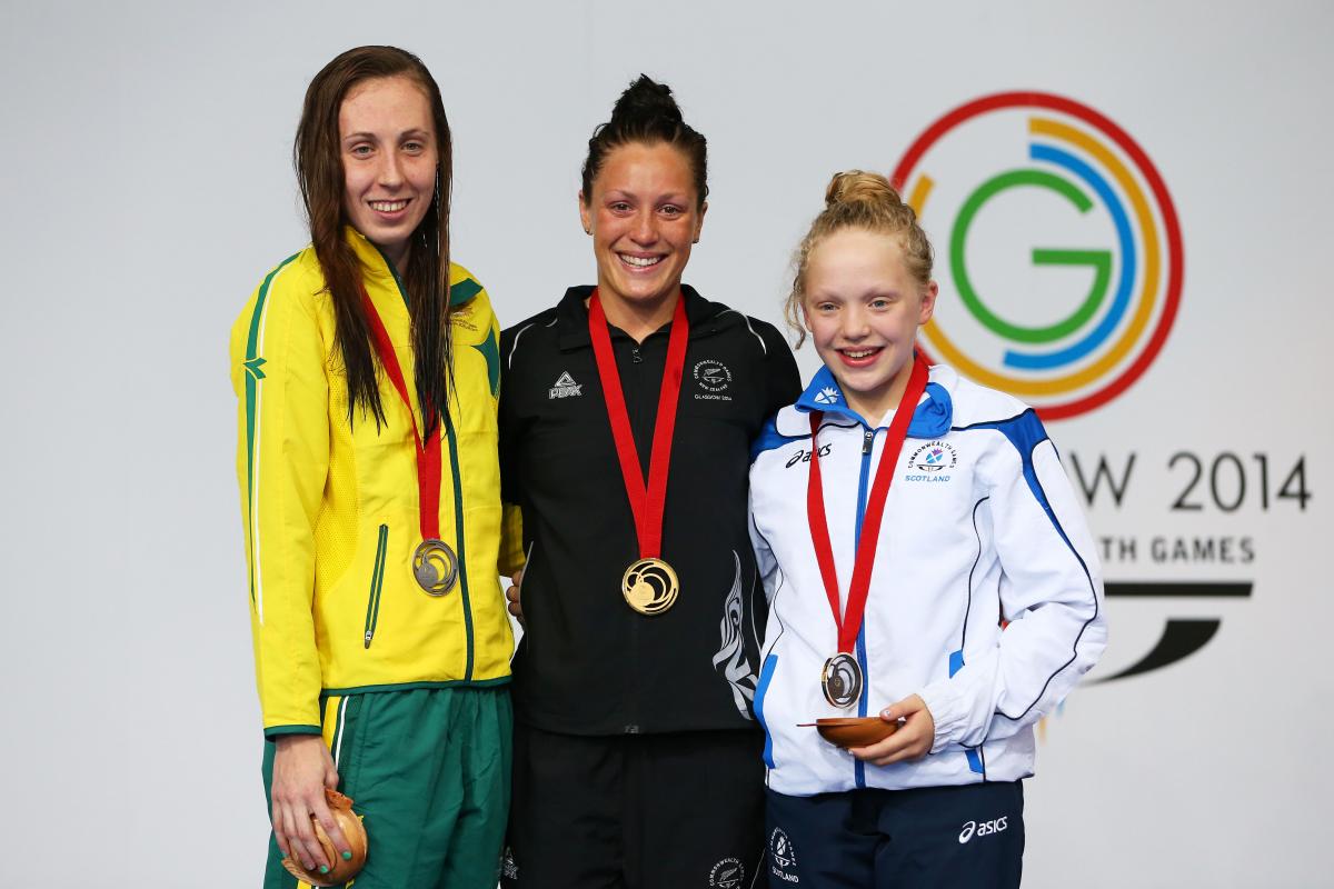 New Zealand's gold medallist Sophie Pascoe with silver medallist Madeleine Scott of Australia and bronze medallist Erraid Davies of Scotland during the medal ceremony for the Women's 100m Breaststroke SB9 Final at Glasgow 2014