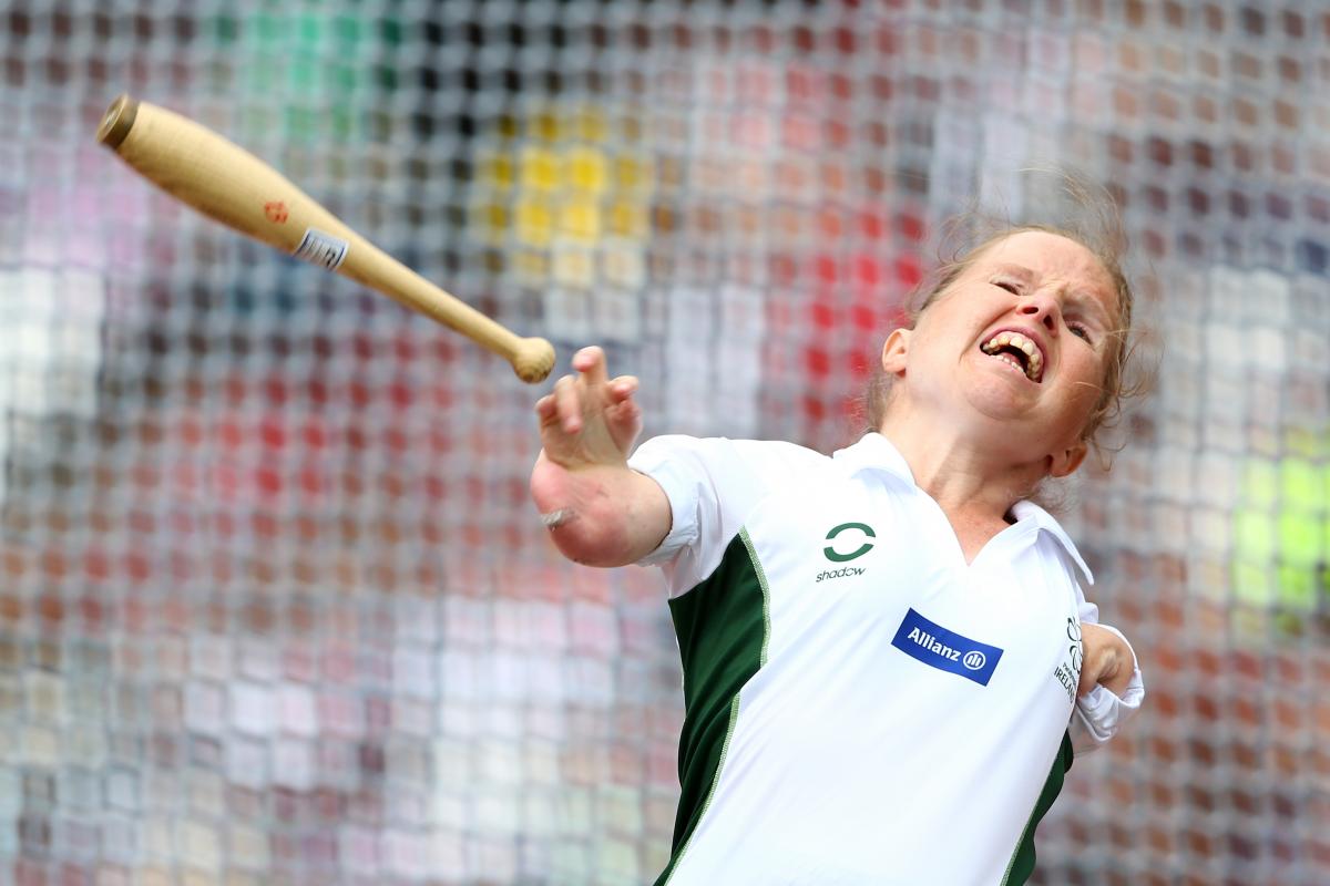 Upper body of a women who is throwing a club