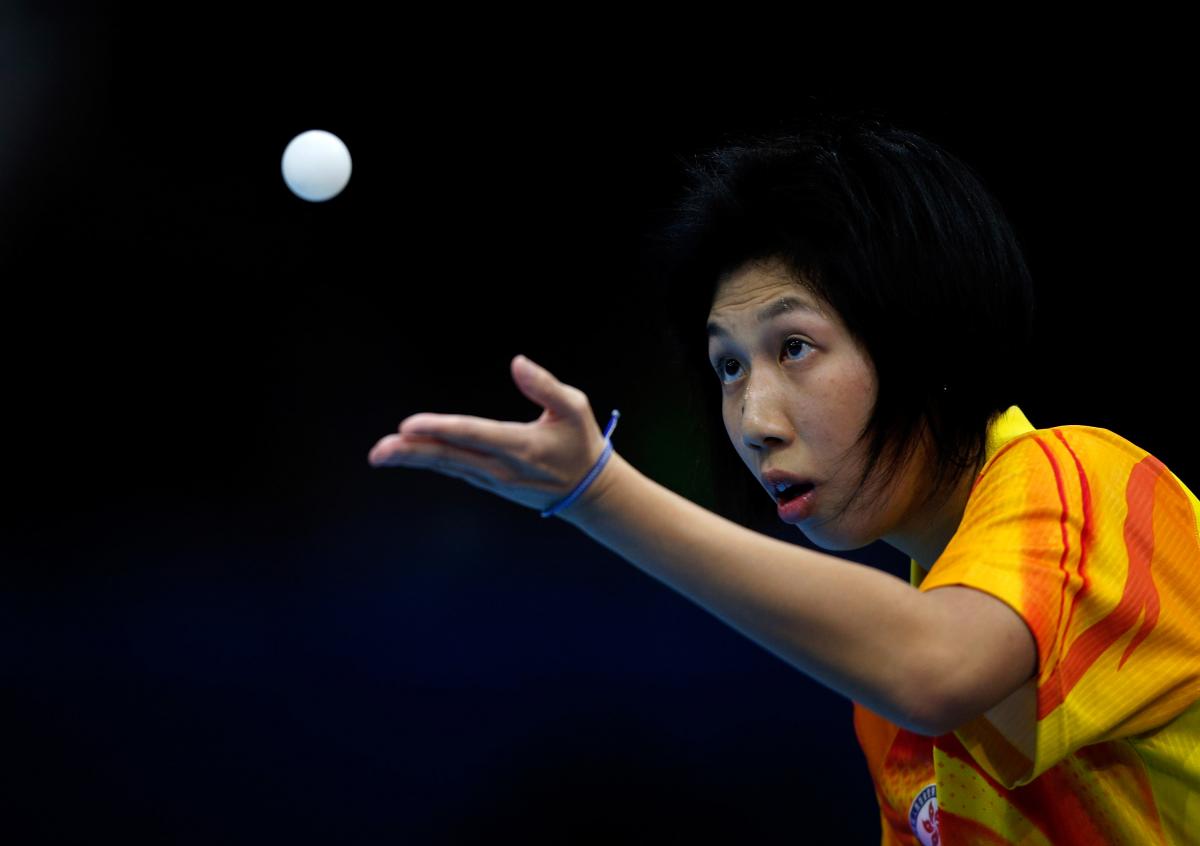 Ka Man Wong of Hong Kong serves during her Women's singles Gold medal match against Chi Ka Yeung of Hong Kong at the London 2012 Paralympic Games.