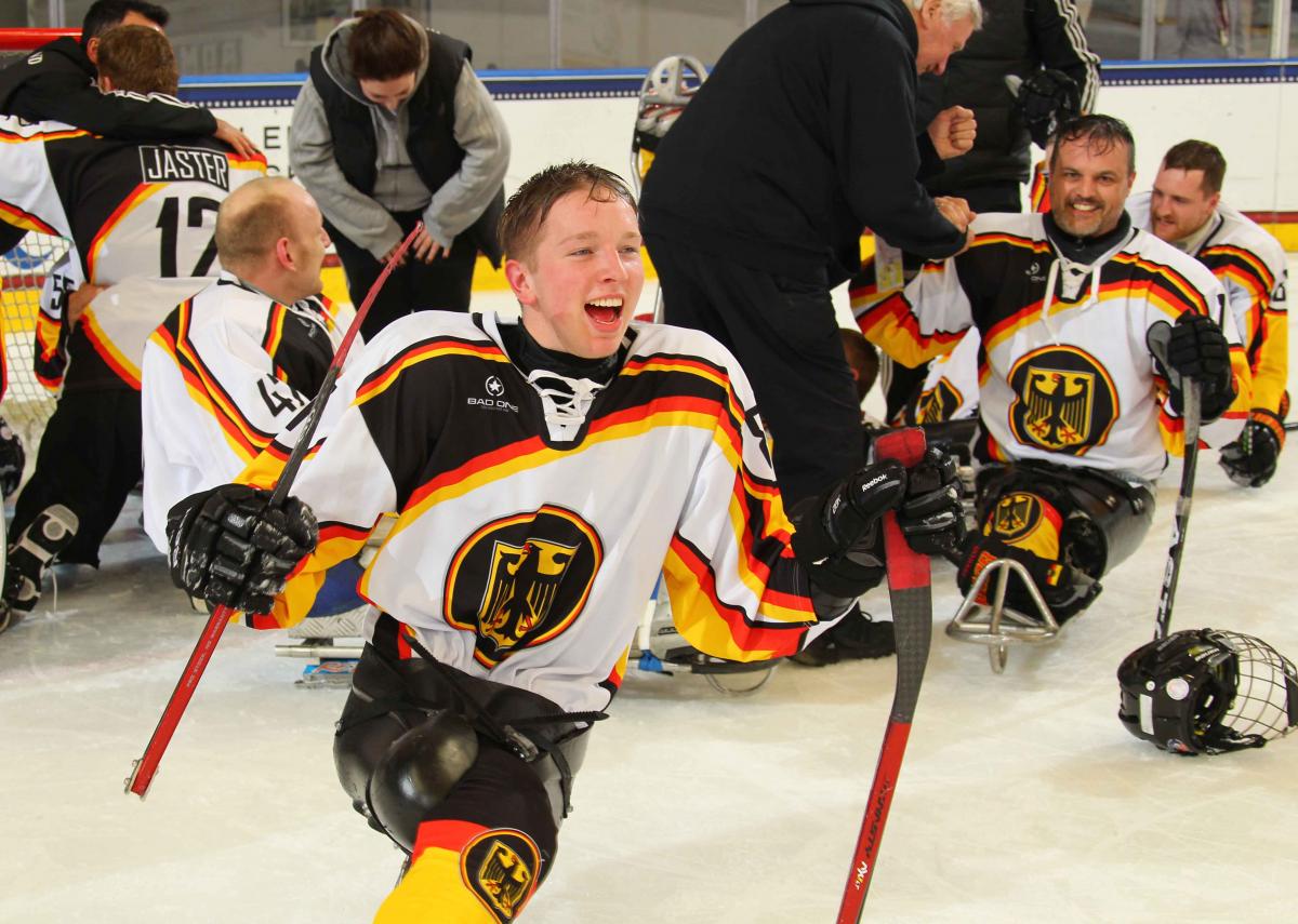 German sledge hockey player cheering.