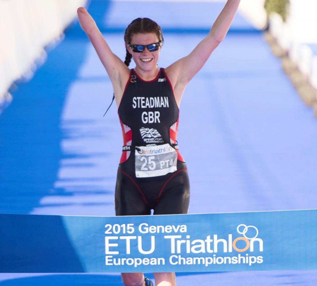 Woman crossing a finish line, celebrating